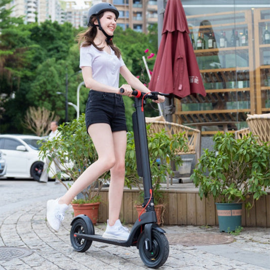 Woman riding an electric scooter outdoor