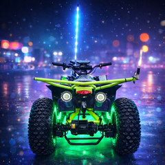 Green ATV with glowing lights on a wet road at night