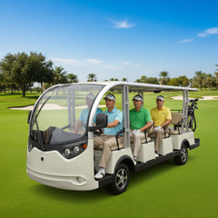 An electric shuttle bus with a capacity of 14 passengers, predominantly white in color, being driven on a road with clear skies and palm trees in the background.