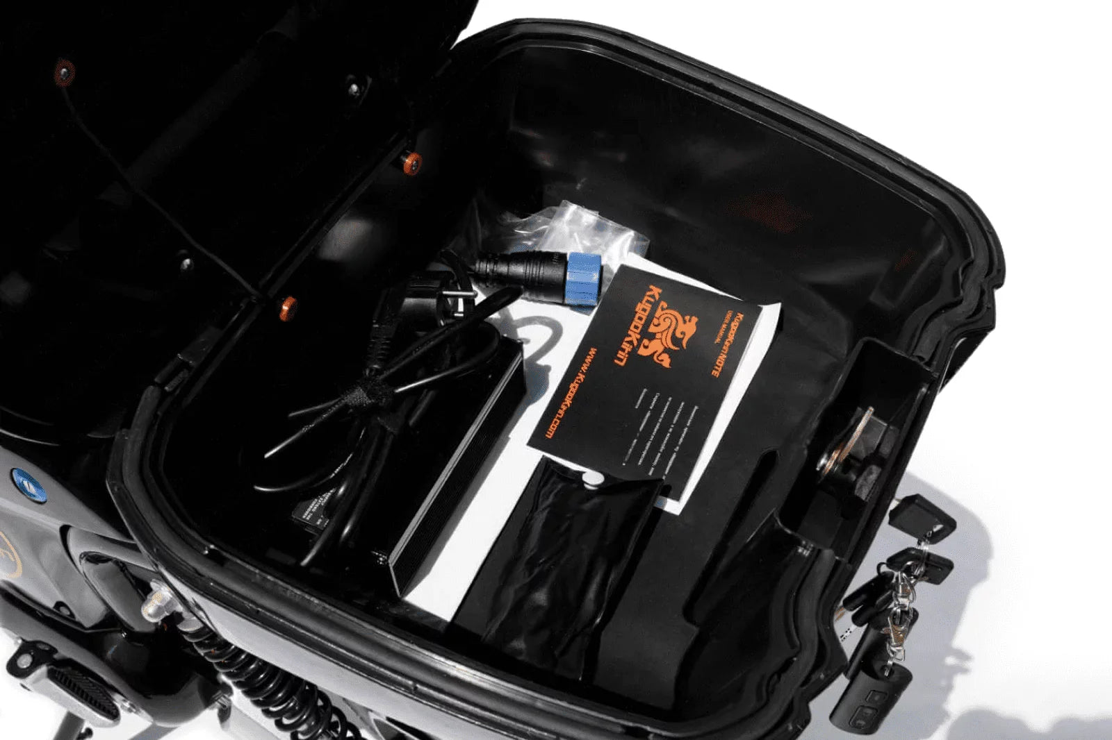 Open suitcase with electronic equipment and a card inside