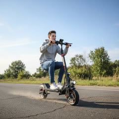 Person riding an Kugoo Electric Scooter 1200W, 54.6v 13AH Battery