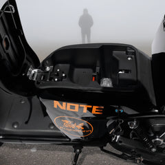 Close-up of a motorcycle battery under seats