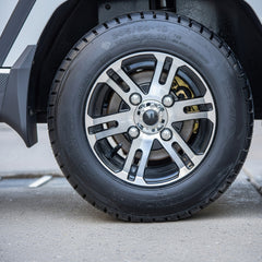 Close-up of a Golf cart tire with a silver alloy wheel on a concrete surface.