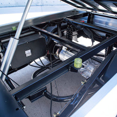 keon Golf cart undercarriage with mechanical components and suspension system.