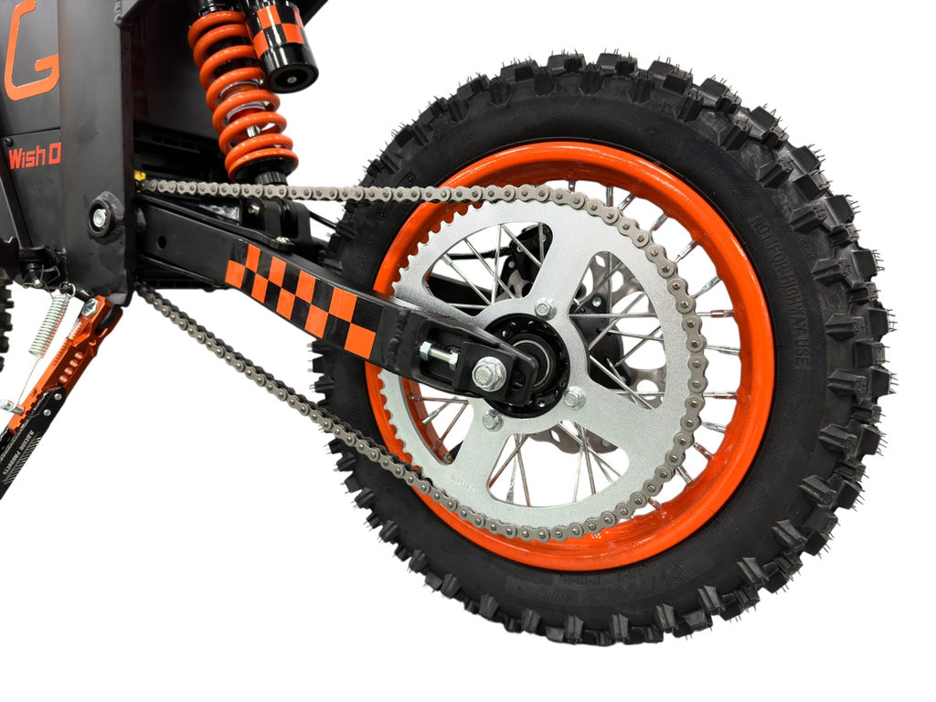 Close-up of a dirt bike wheel with orange rim and black tire