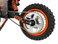 Close-up of a dirt bike wheel with orange rim and black tire