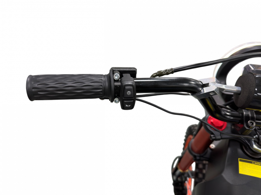 Close-up of a motorcycle handlebar with black grips and control buttons