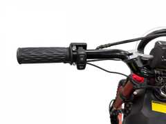 Close-up of a motorcycle handlebar with black grips and control buttons
