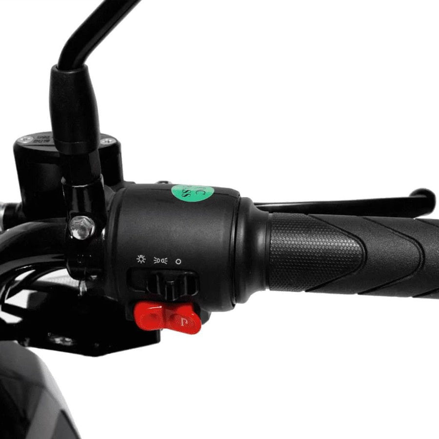 Close-up of a motorcycle handlebar with control buttons 
