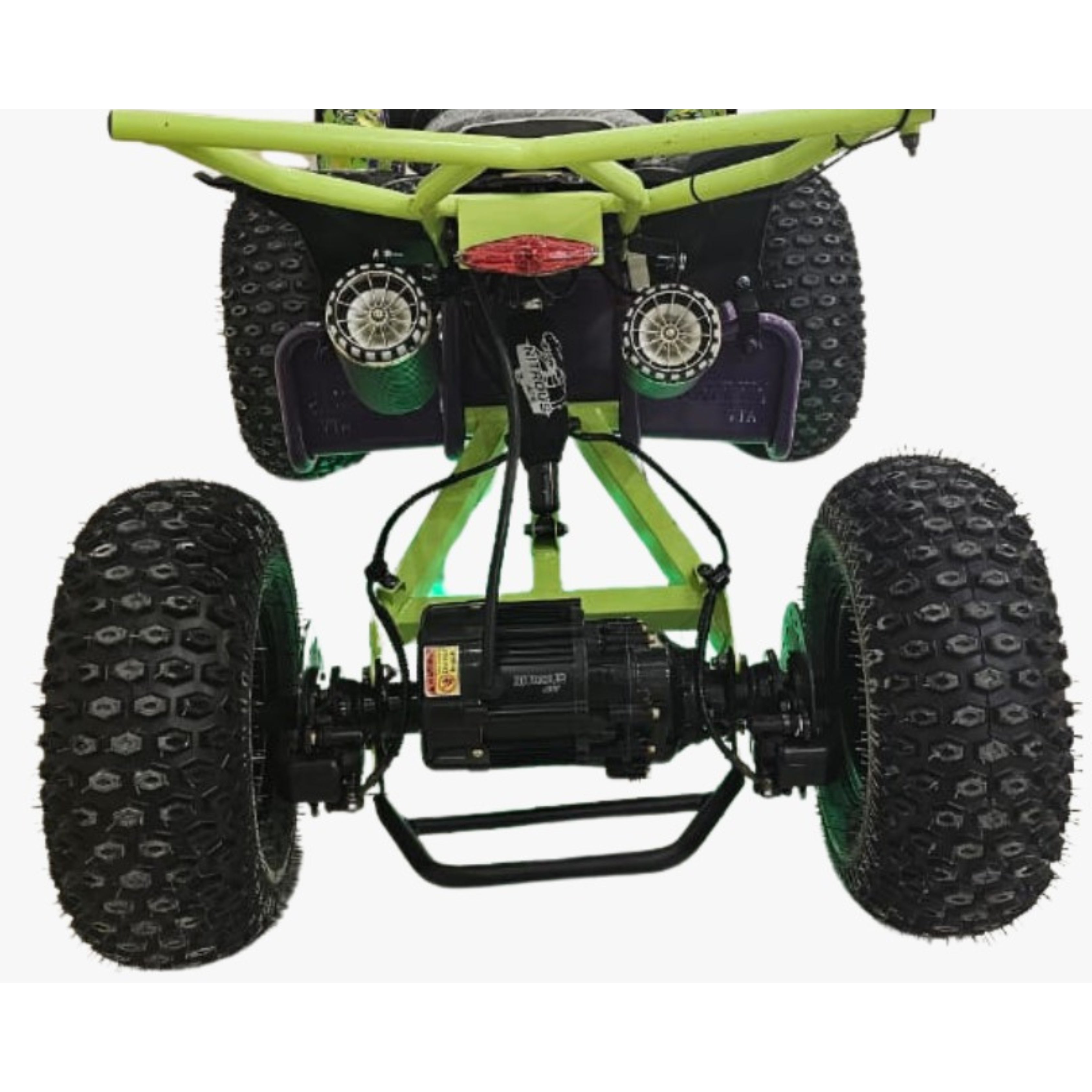 Close-up of a green ATV with large black Off Road tires 