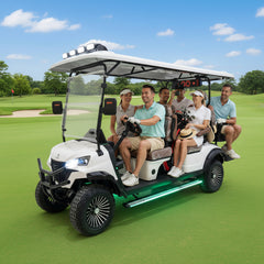 Group of people riding in a white golf cart on a golf course