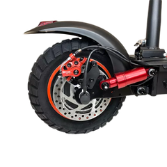 Close-up of a scooter wheel with red suspension fork 