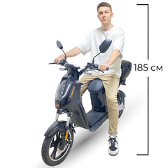Person sitting on a motorcycle with dimensions indicated
